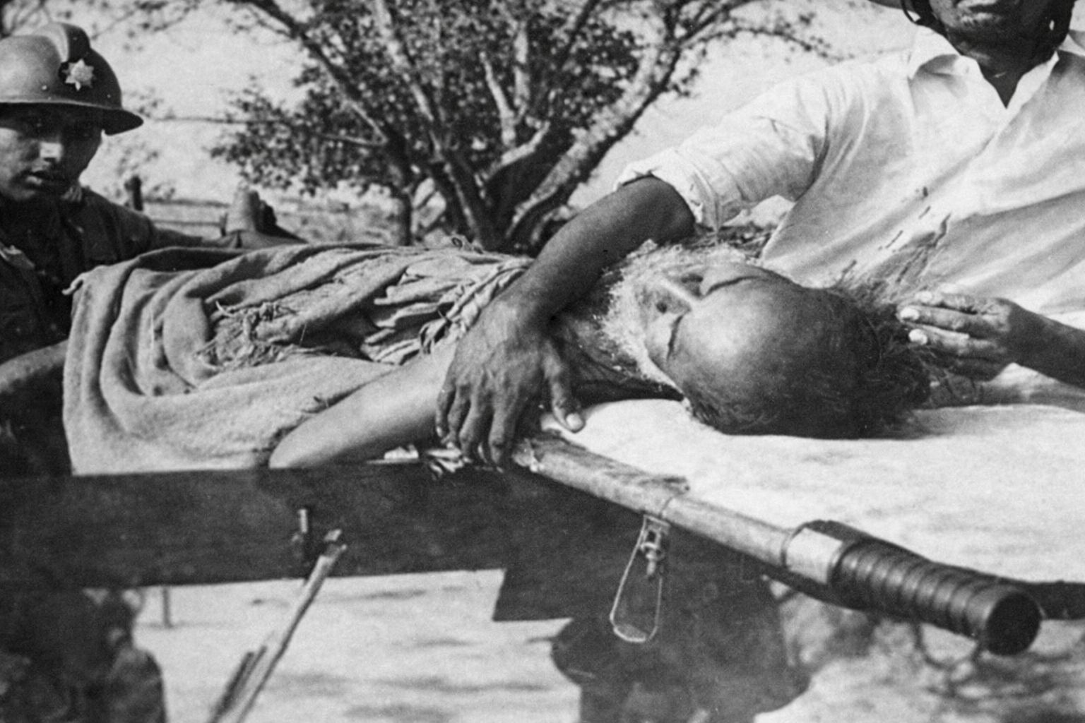 A wounded policeman being taken away from the Rajarbagh Police Lines after the Pakistani Army's attack.